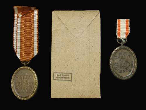 2 x Westwall Medals with an Original Packet of Issue by Carl Poellath.